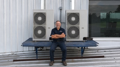 HVAC technician at work on commercial equipment